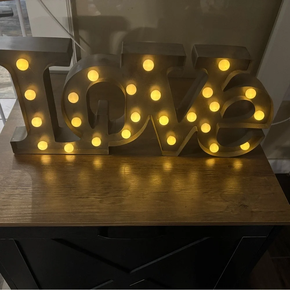 Silver Love Sign with Warm Yellow Lights